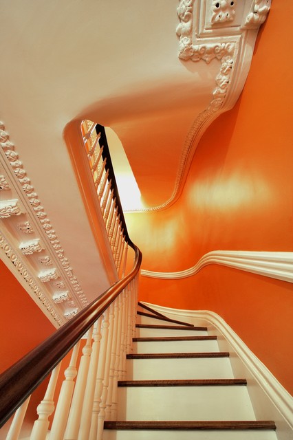 Современный дизайн лестницы в оранжевых сполохах.